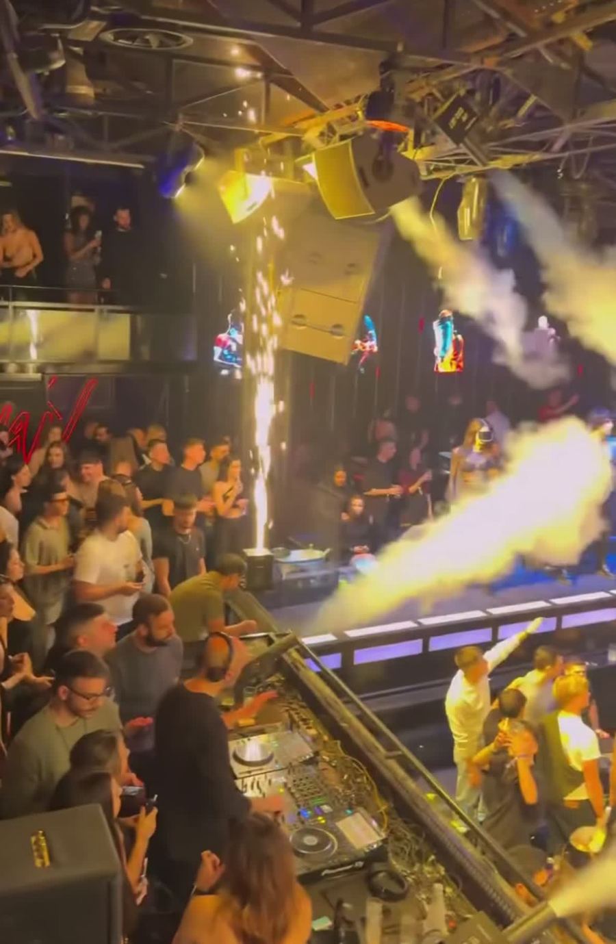 Packed club in Athens with sparklers and CO2 jets over the DJ booth